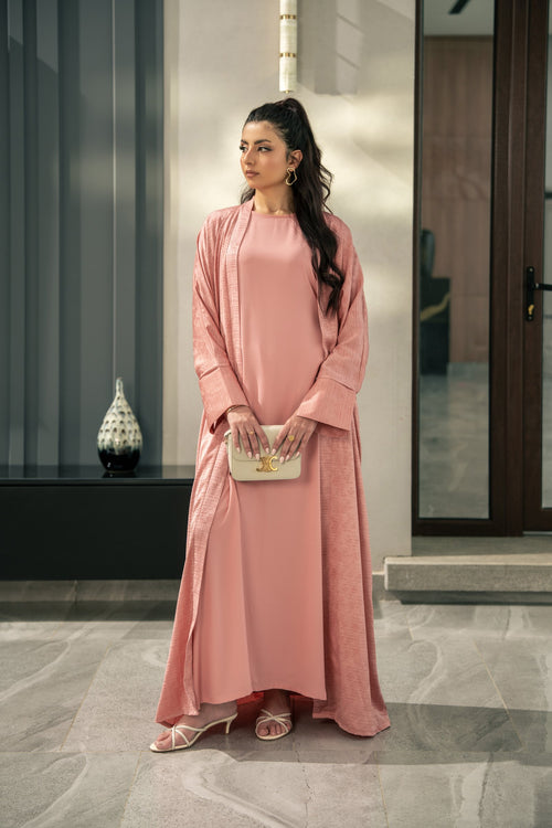 Blush kimono set worn as all three pieces: the open kimono over the sleeveless inner and wide-leg trousers.