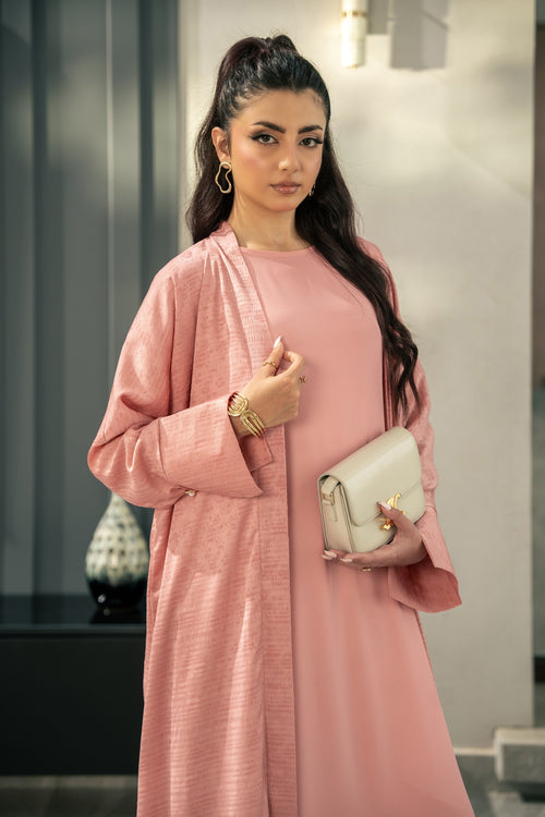 The Blush kimono from the waist up, worn open over the pink inner.