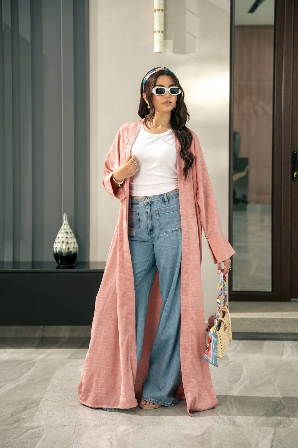 The Blush kimono styled on its own over jeans, showing how it layers.