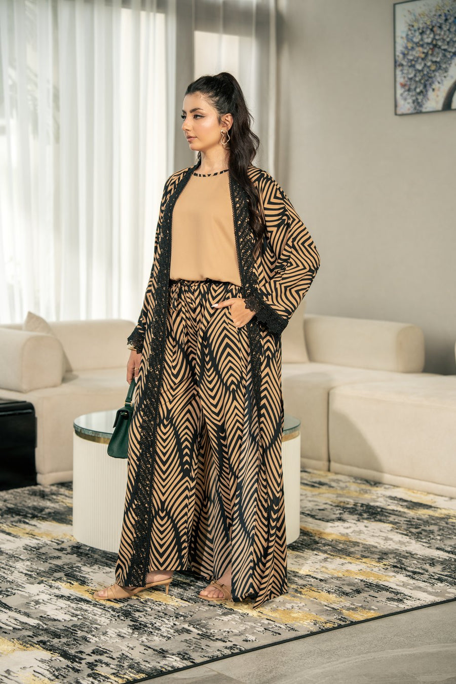 Onyx kimono set indoors, hands in the trouser pockets.