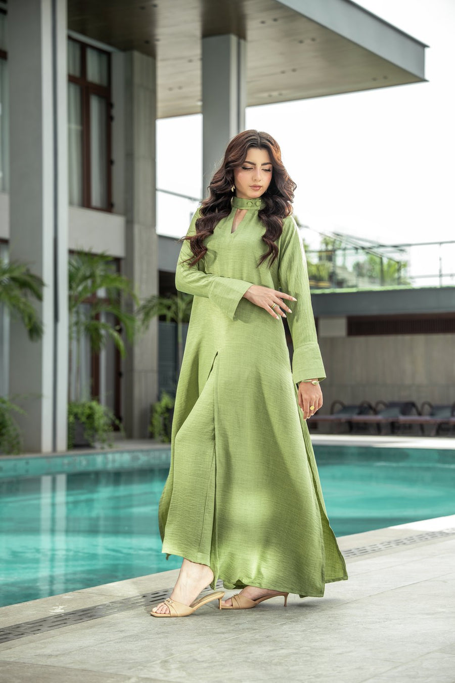 Sage shirt full length, the wide bell cuff falling open.