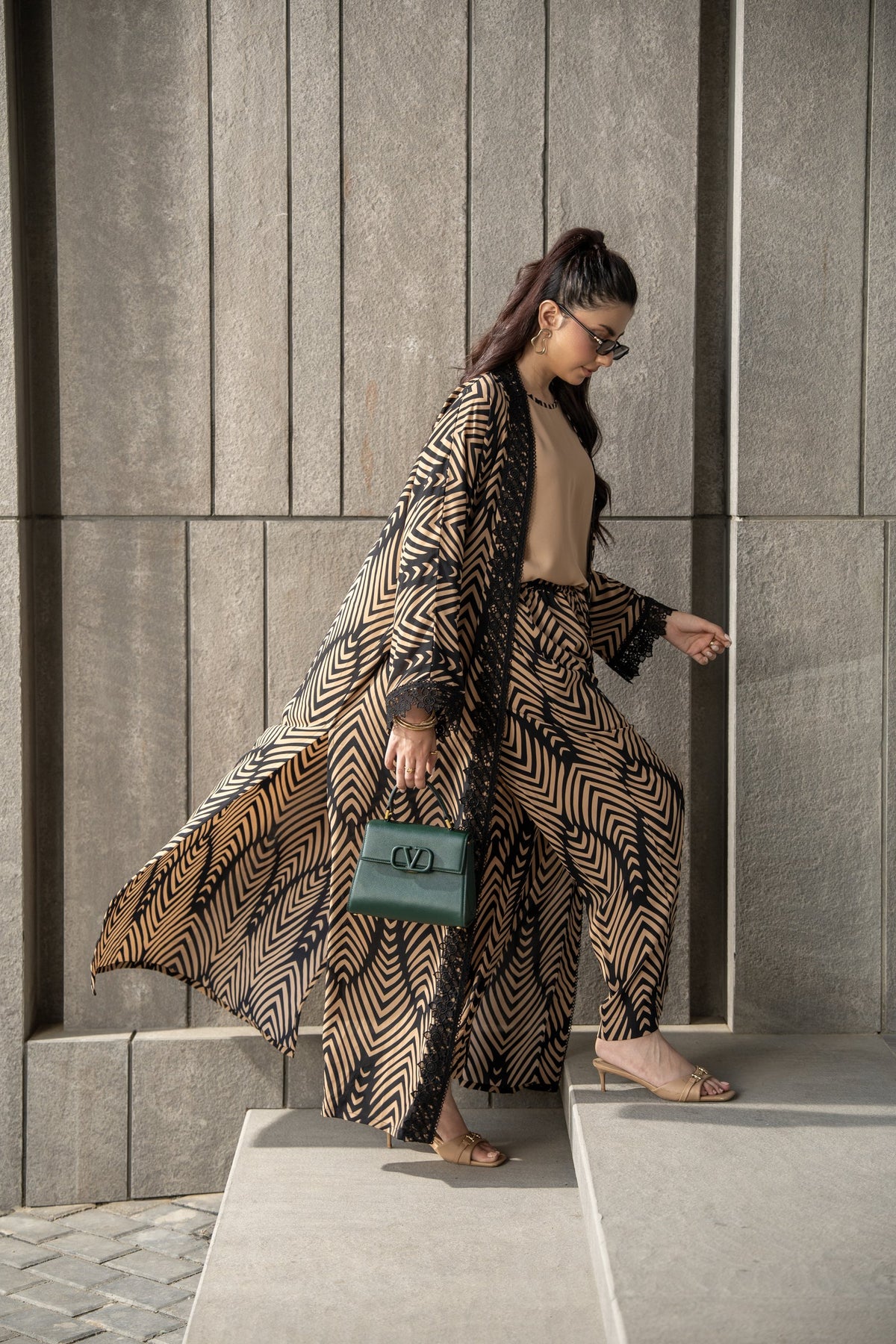 Onyx kimono set in mid step, the printed kimono opening over the matching trousers.