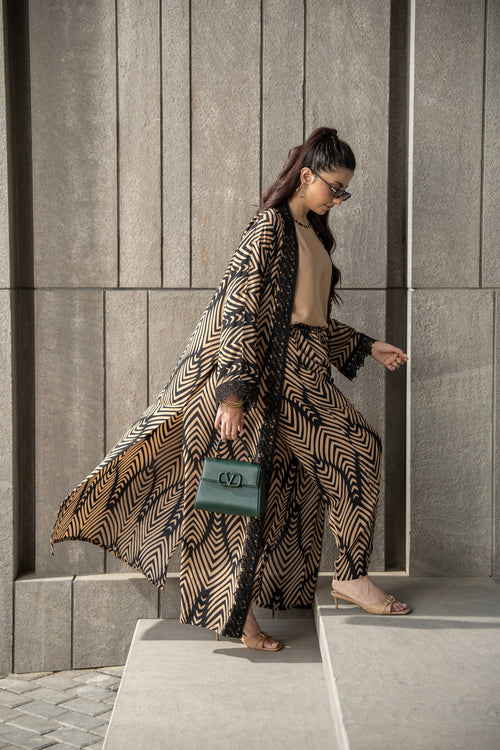 Onyx kimono set in mid step, the printed kimono opening over the matching trousers.