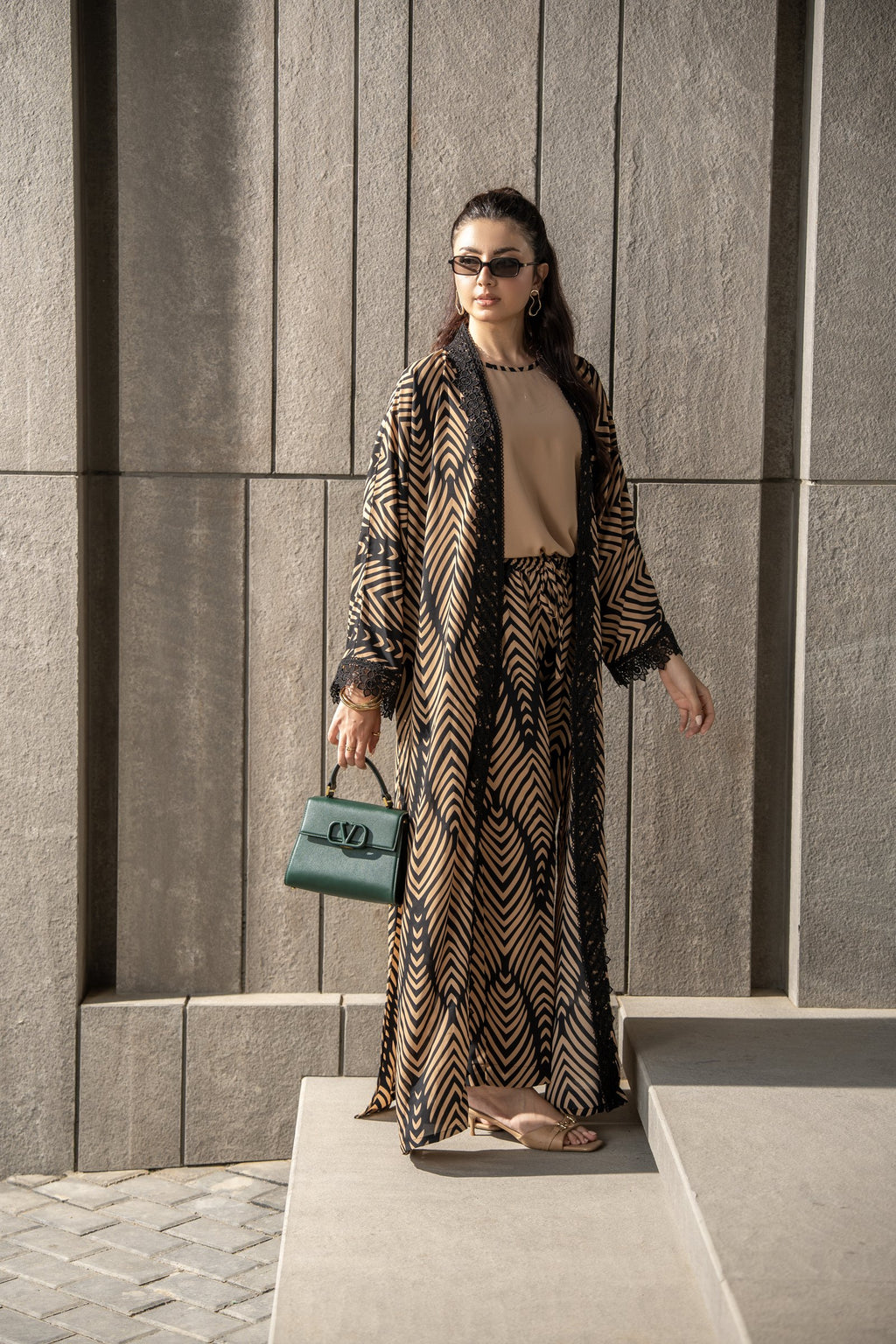 Onyx kimono set seen full length against a stone wall.