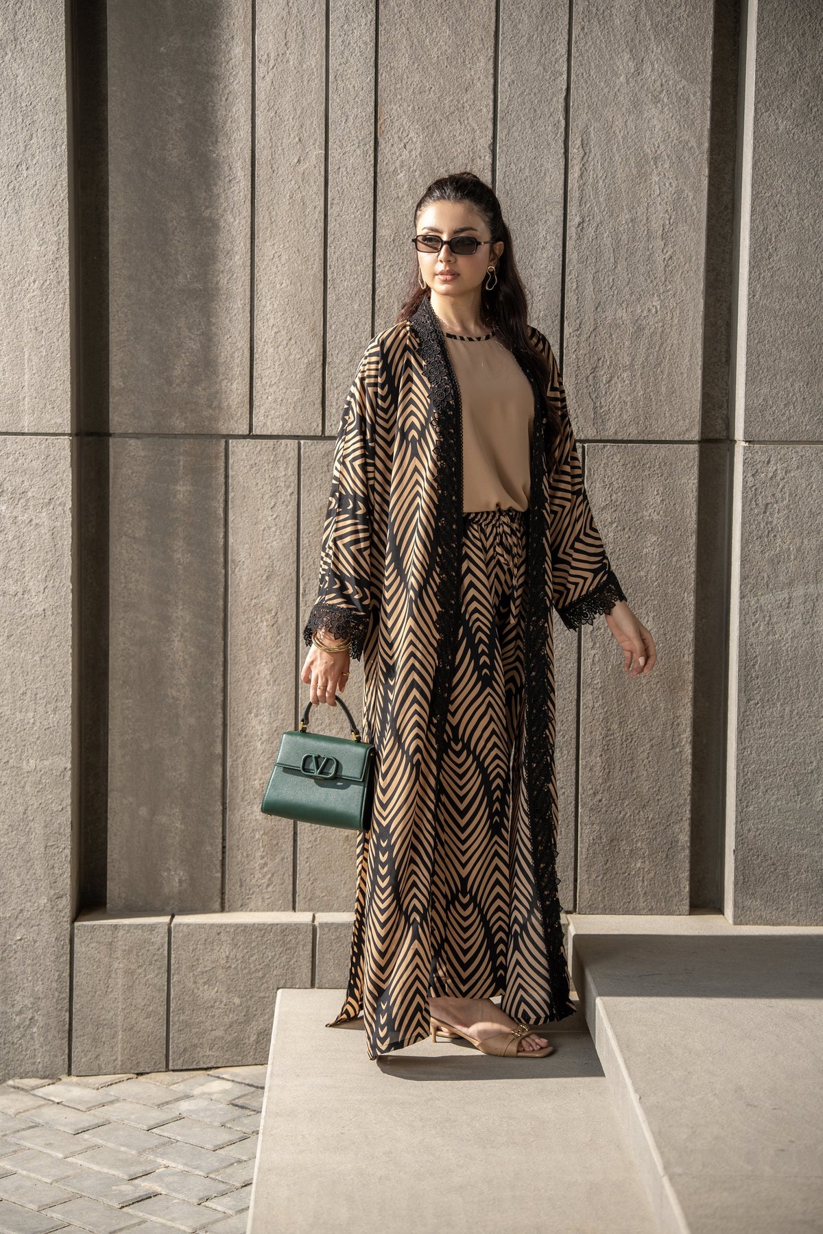 Onyx kimono set seen full length against a stone wall.