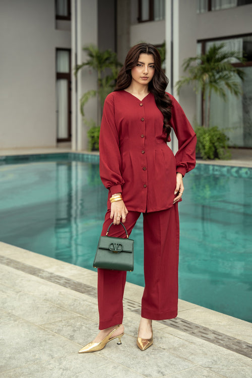 Ruby deep maroon co-ord worn poolside, the shirt falling over wide-leg trousers.