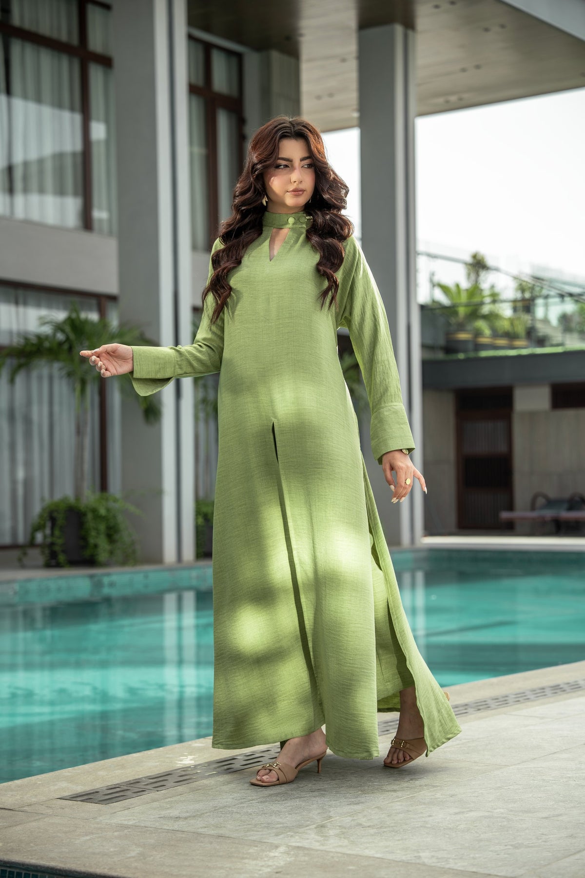 Sage long olive green shirt worn poolside over matching wide-leg trousers.